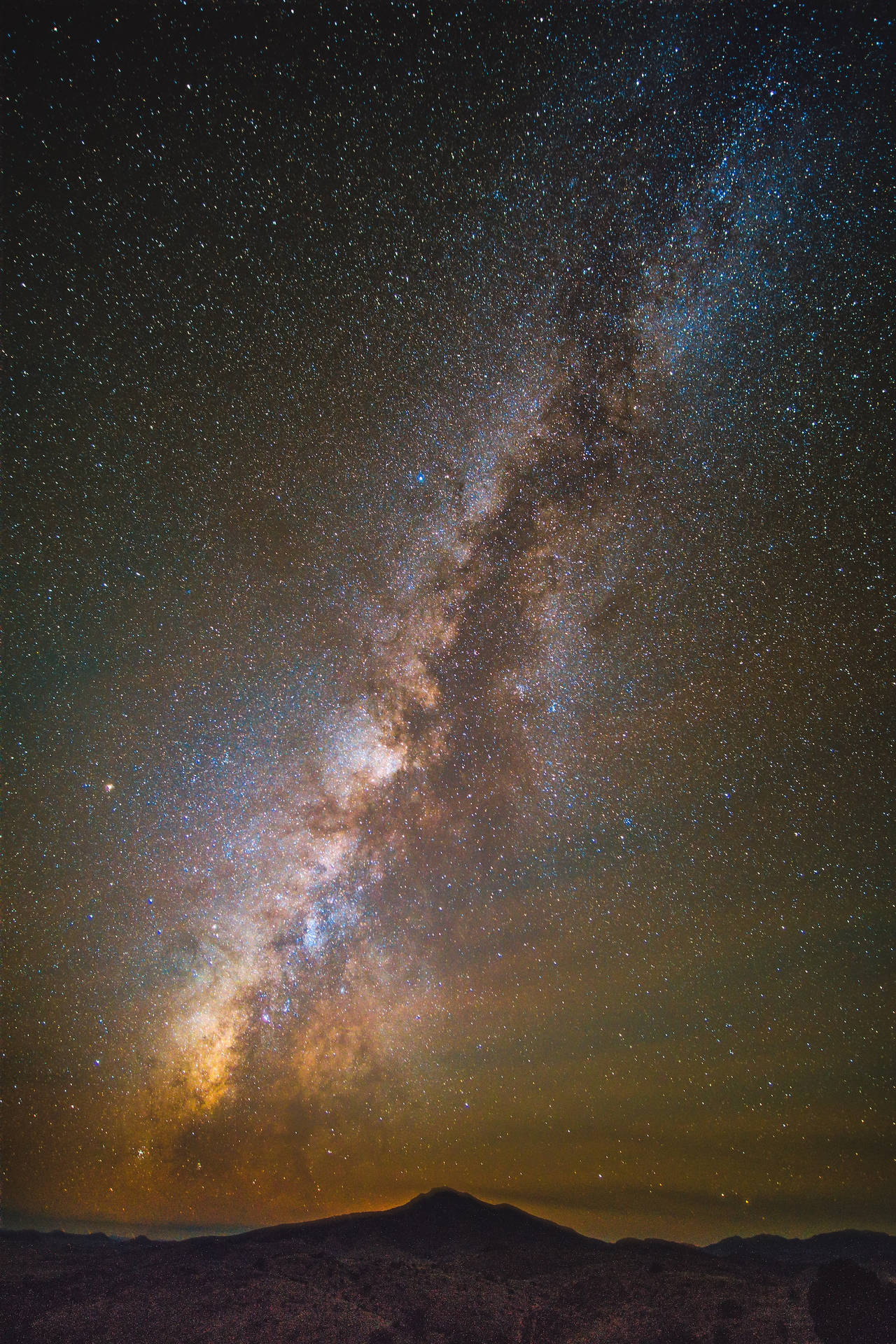 Andromeda Galaxy Over A Mountain Background