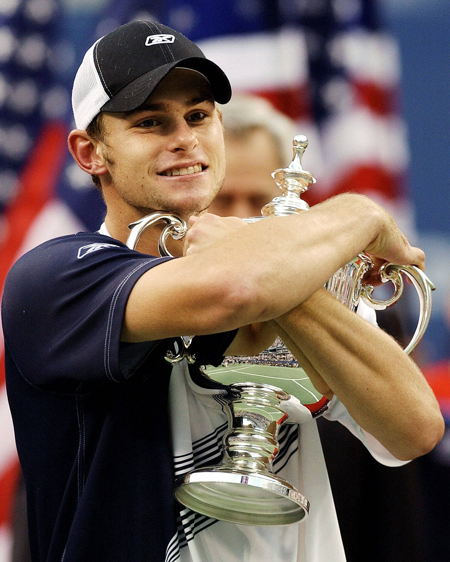 Andy Roddick Holding The 2003 Us Open Tennis Trophy Background