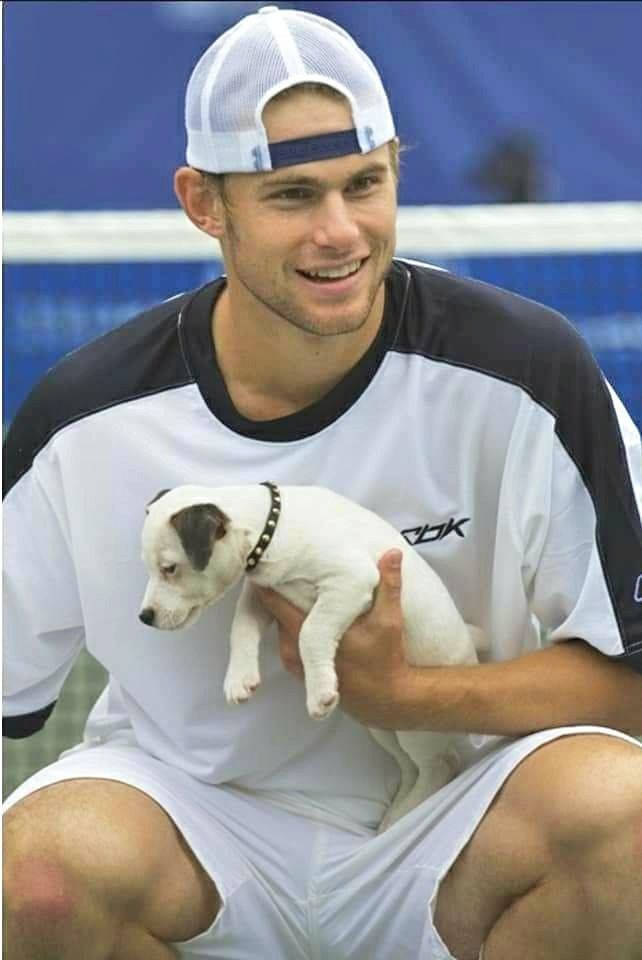 Andy Roddick Holding White Puppie Background