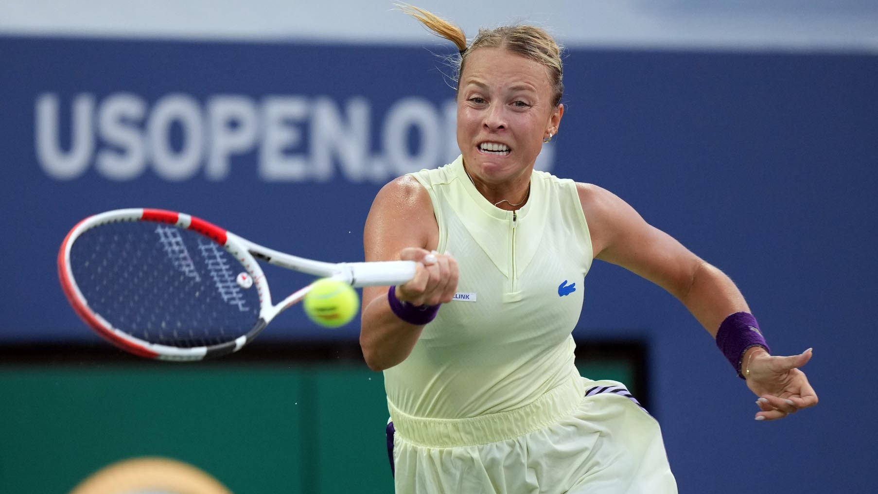 Anett Kontaveit In Yellow Striking Ball Background