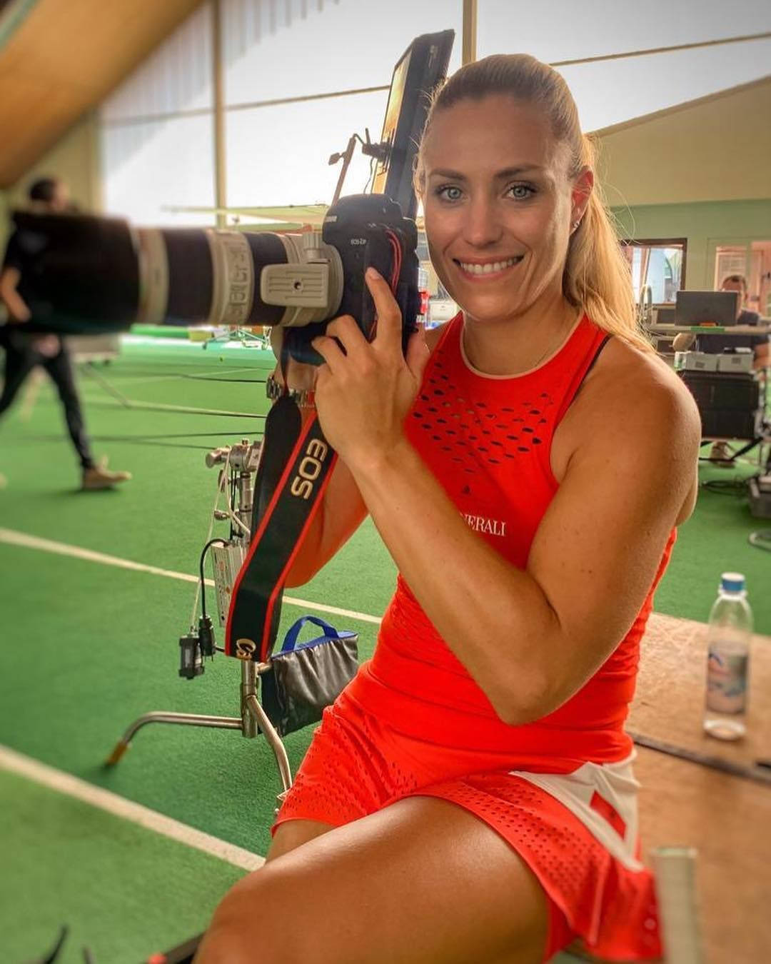 Angelique Kerber Holding A Camera Background