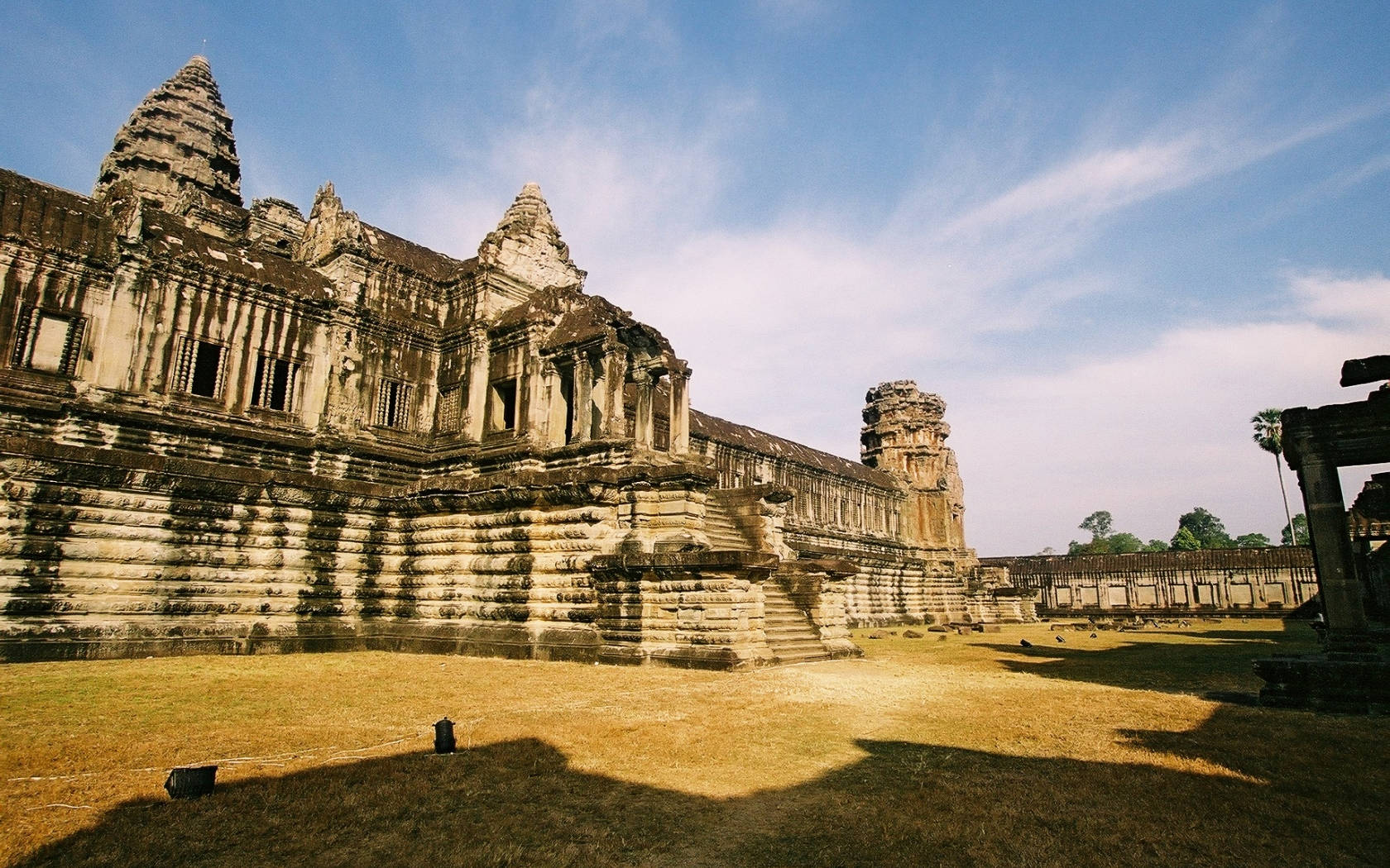 Angkor Wat Ruins In Cambodia Beneath Blue Sky Background