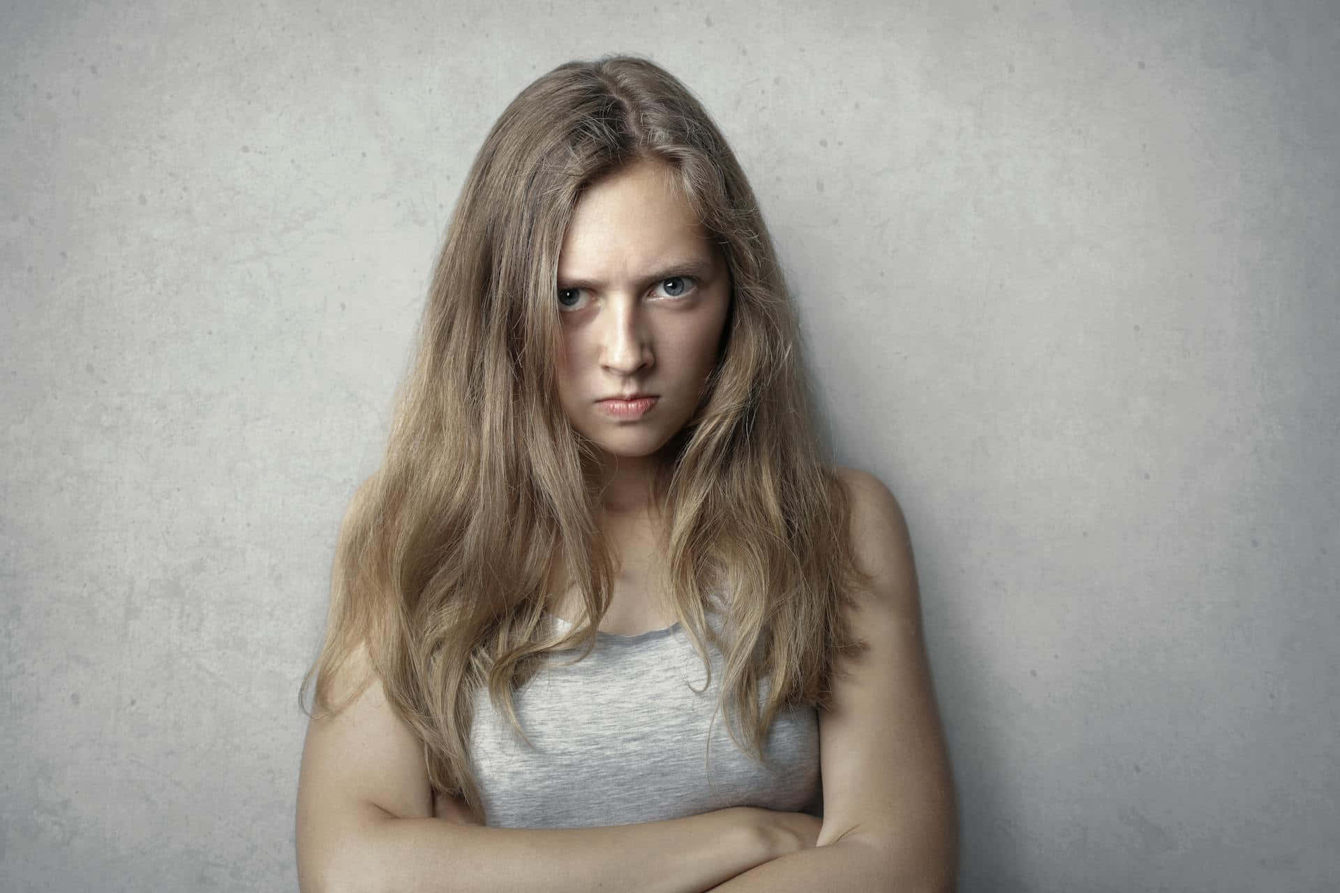 Angry Young Woman Arms Crossed.jpg Background