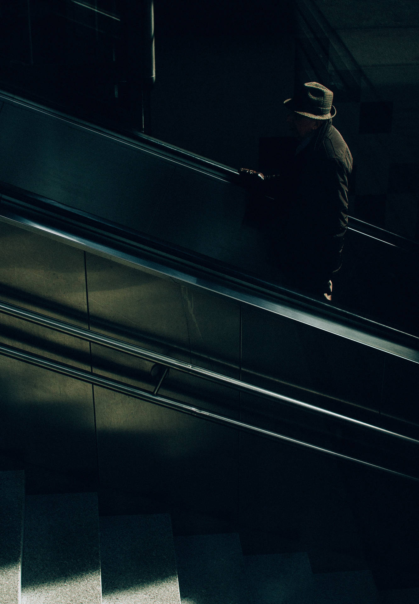Anonymous Man Riding An Escalator Background