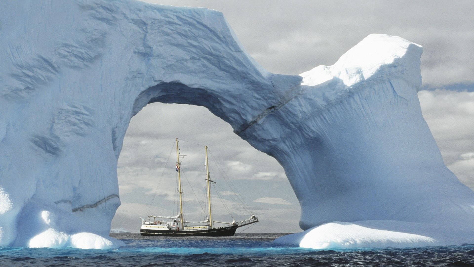 Antarctica Arch Glacier And Ship Background