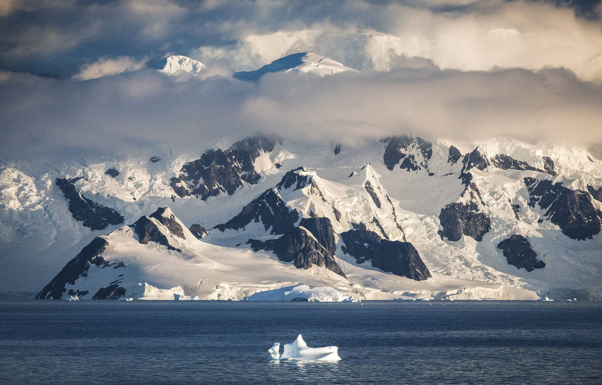 Antarctica Mountain Covered By Clouds Background