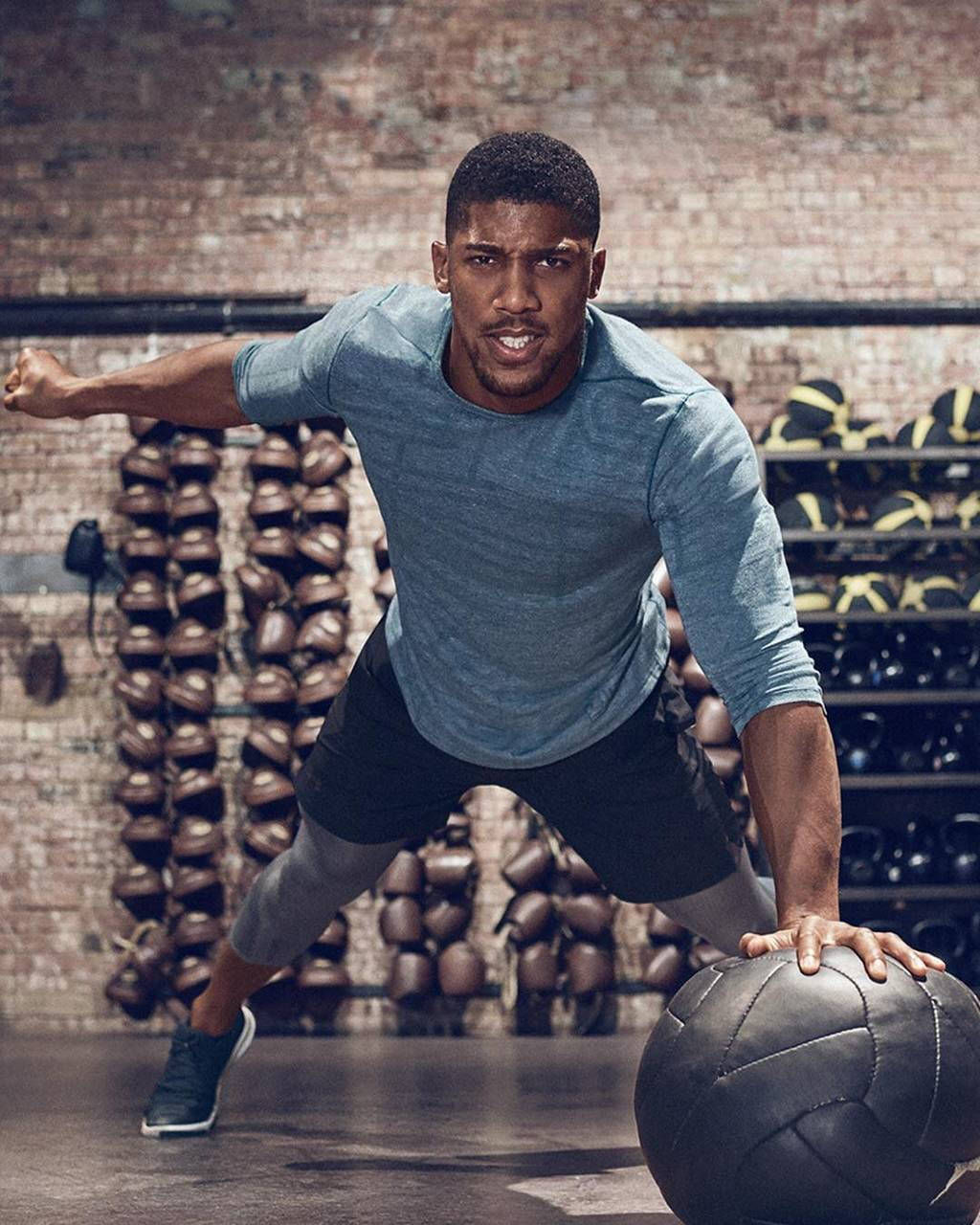 Anthony Joshua Holding Down Ball Background