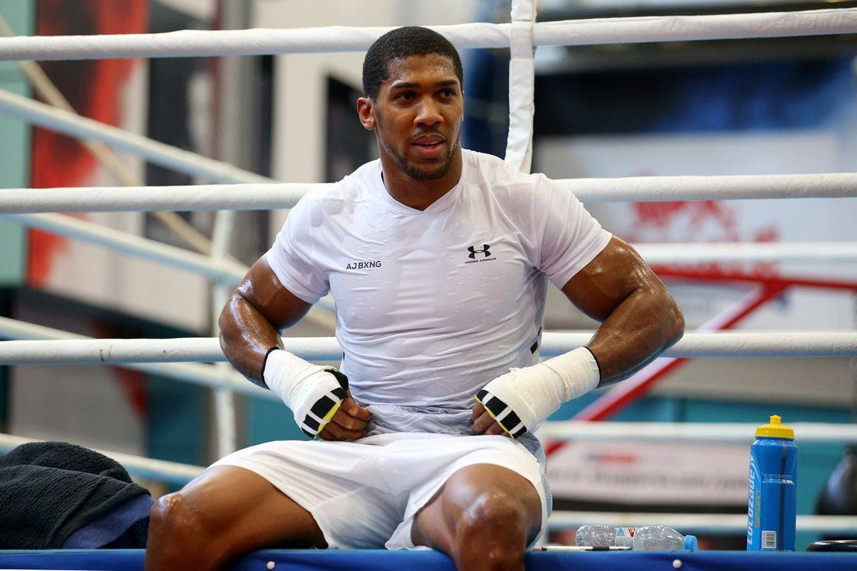 Anthony Joshua Posing In A White Shirt Background