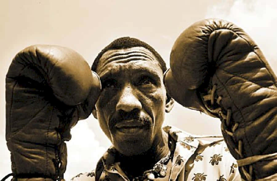 Antonio Cervantes Wearing Gloves In A Boxing Position Background