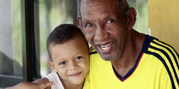 Antonio Cervantes With His Grandson Smiling Background