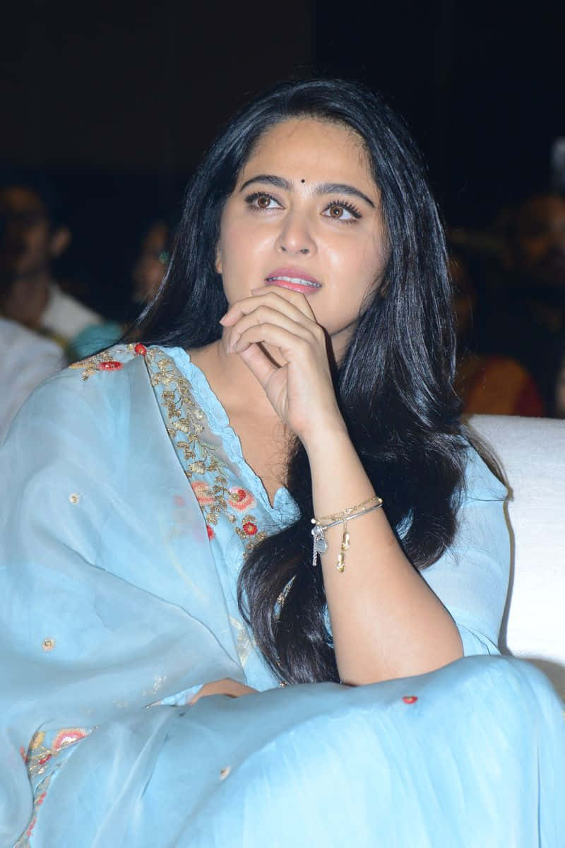 Anushka Shetty Contemplative Look Event Background