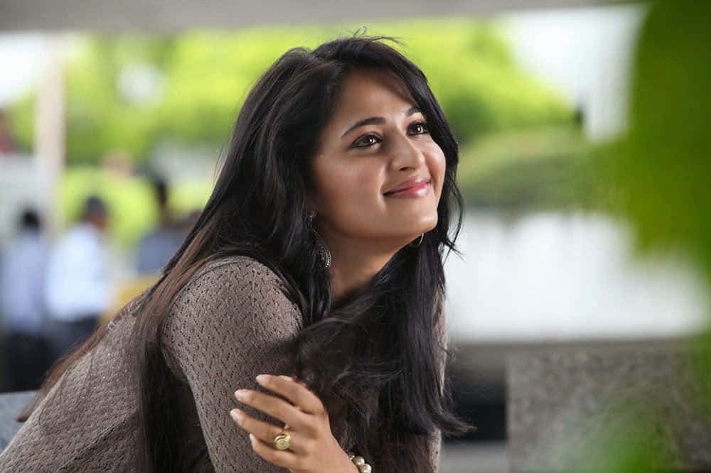 Anushka Shetty Smiling Portrait Background