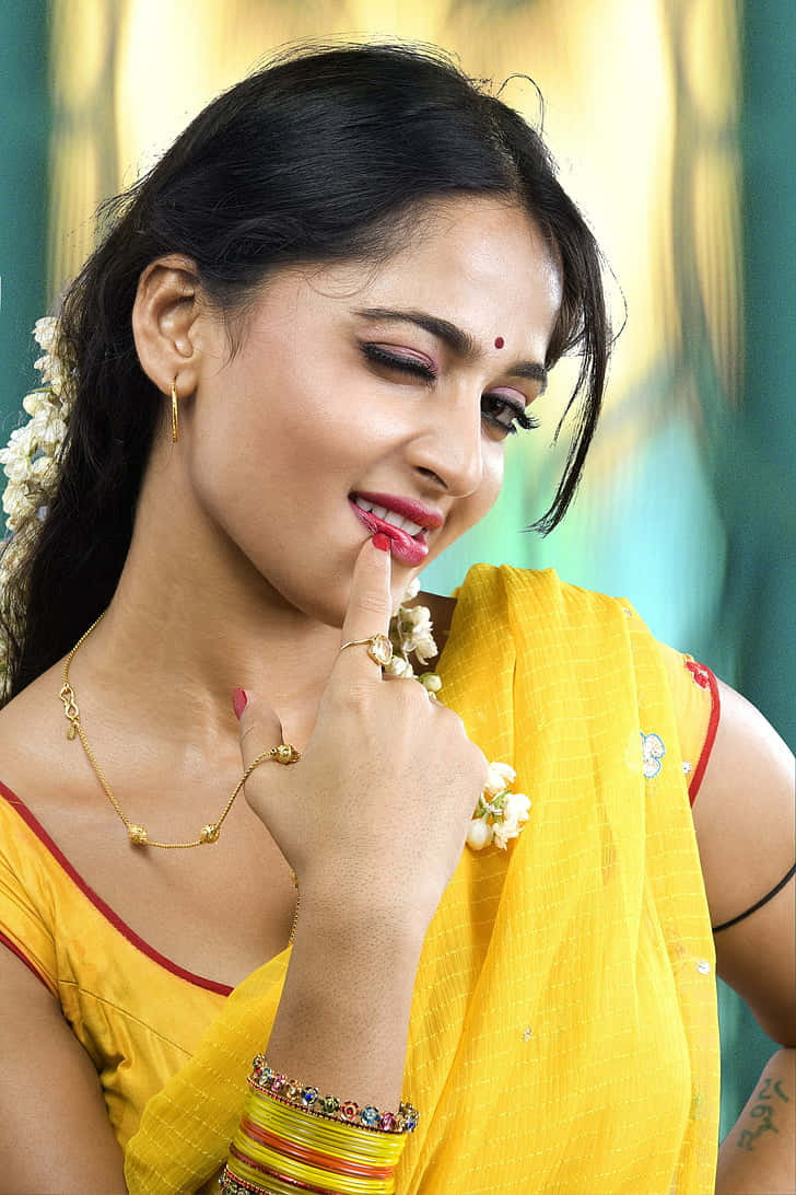 Anushka Shetty Yellow Saree Traditional Look Background