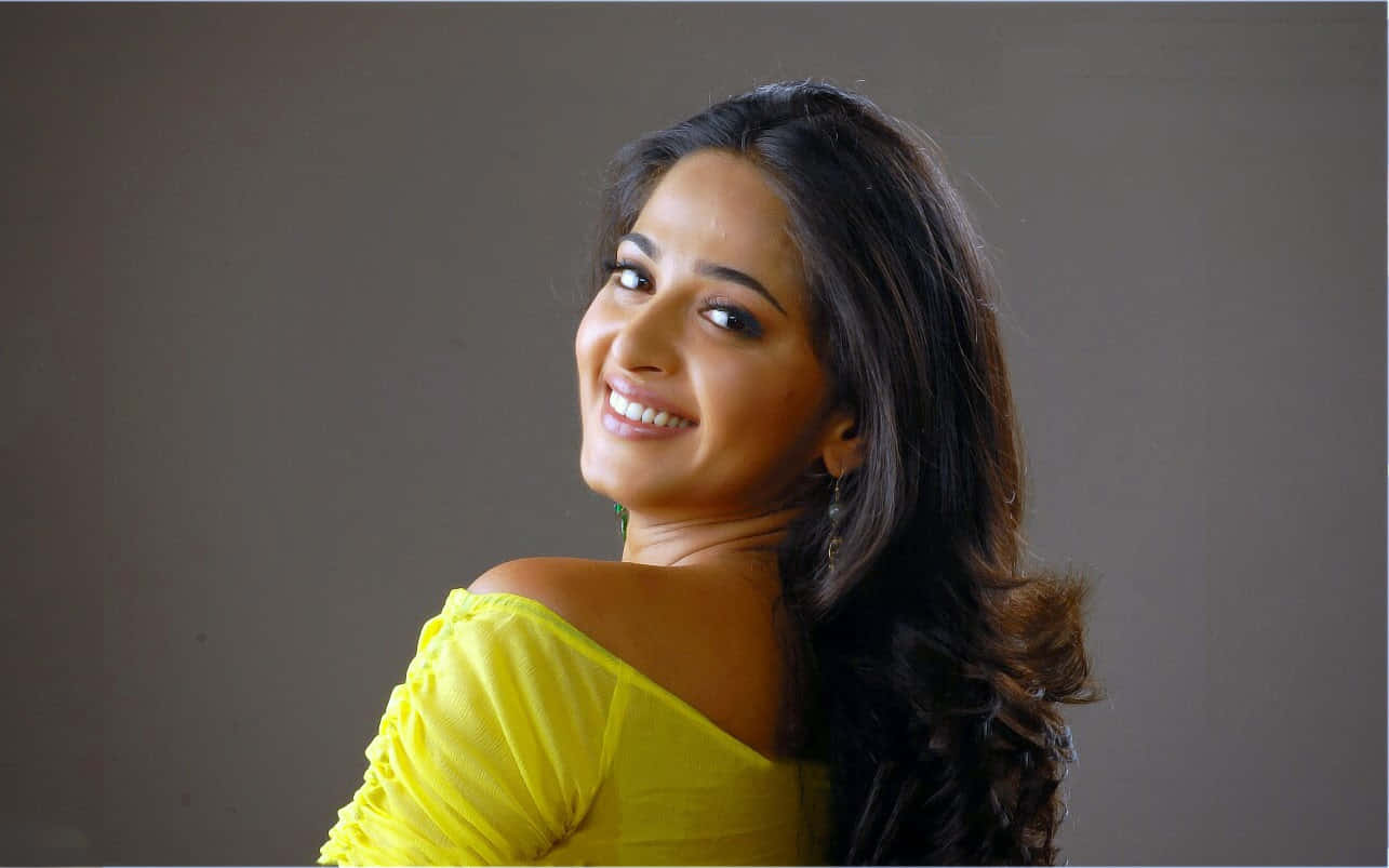 Anushka Shetty Yellow Top Glamorous Look Background