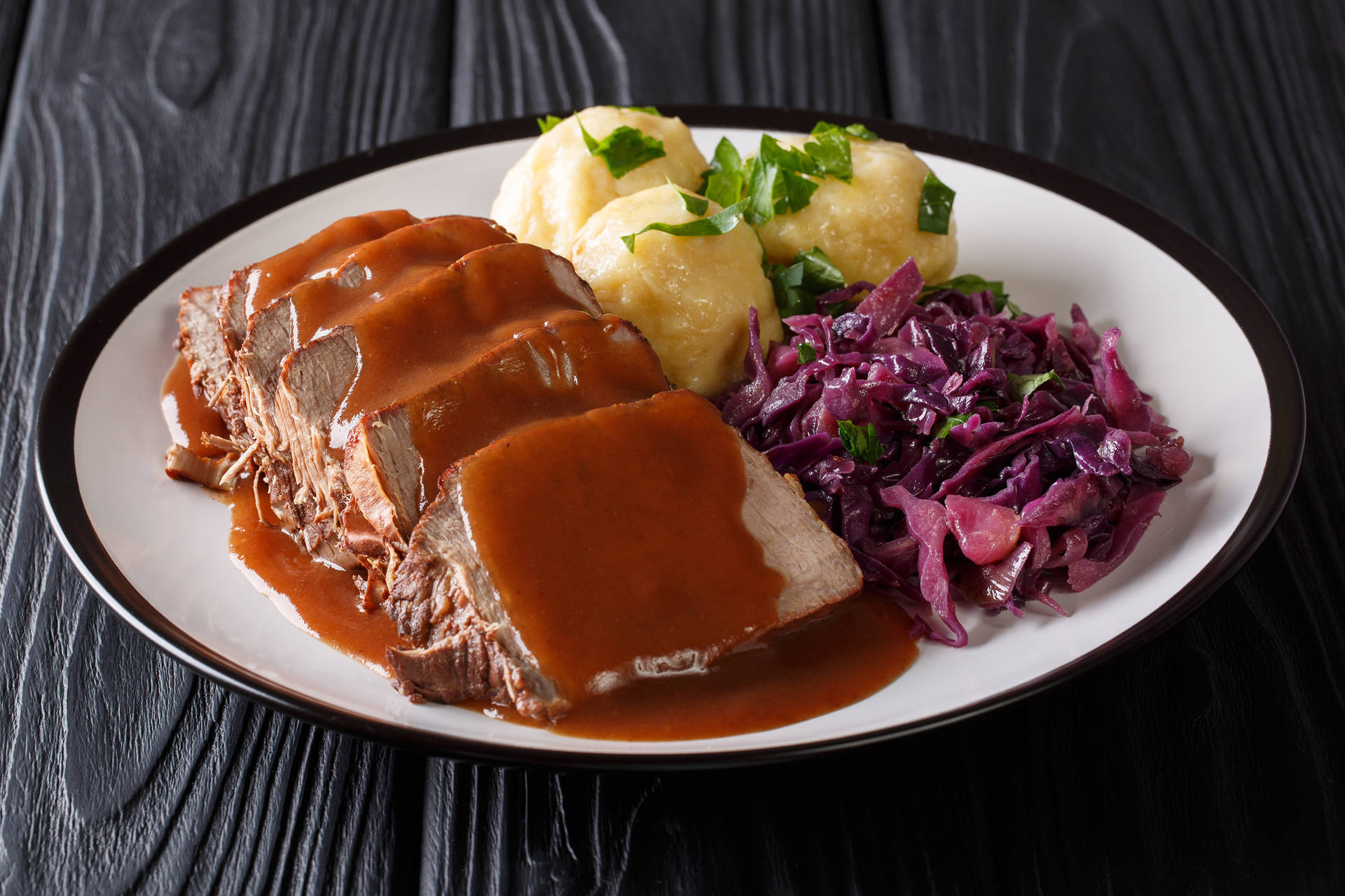 Appetizing Sauerbraten - A Traditional German Roast Dish With Brown Sauce Background