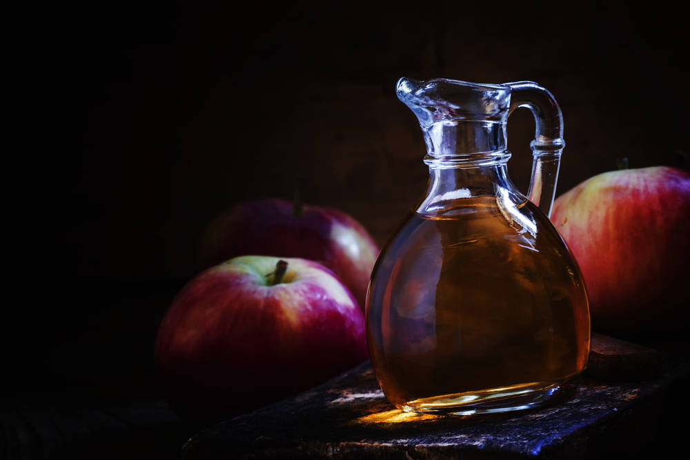 Apple Cider Vinegar With Apples Background