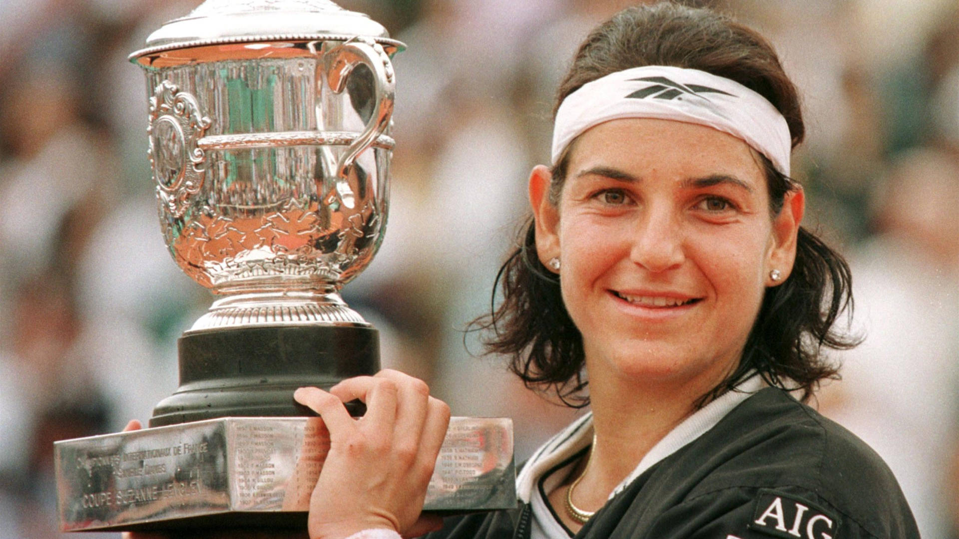 Arantxa Sanchez Vicario Triumphantly Lifts The Trophy At The 1998 French Open Tennis Tournament Background