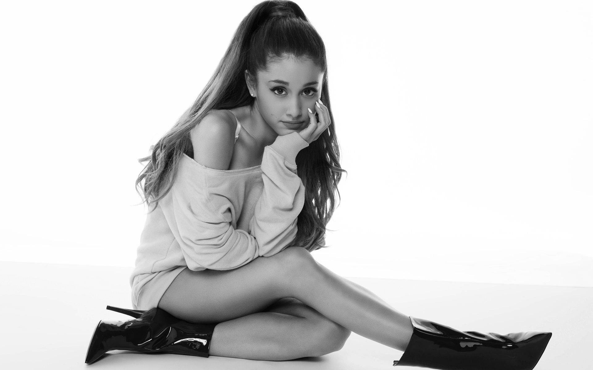 Ariana Grande Crossed Legs On Floor Background