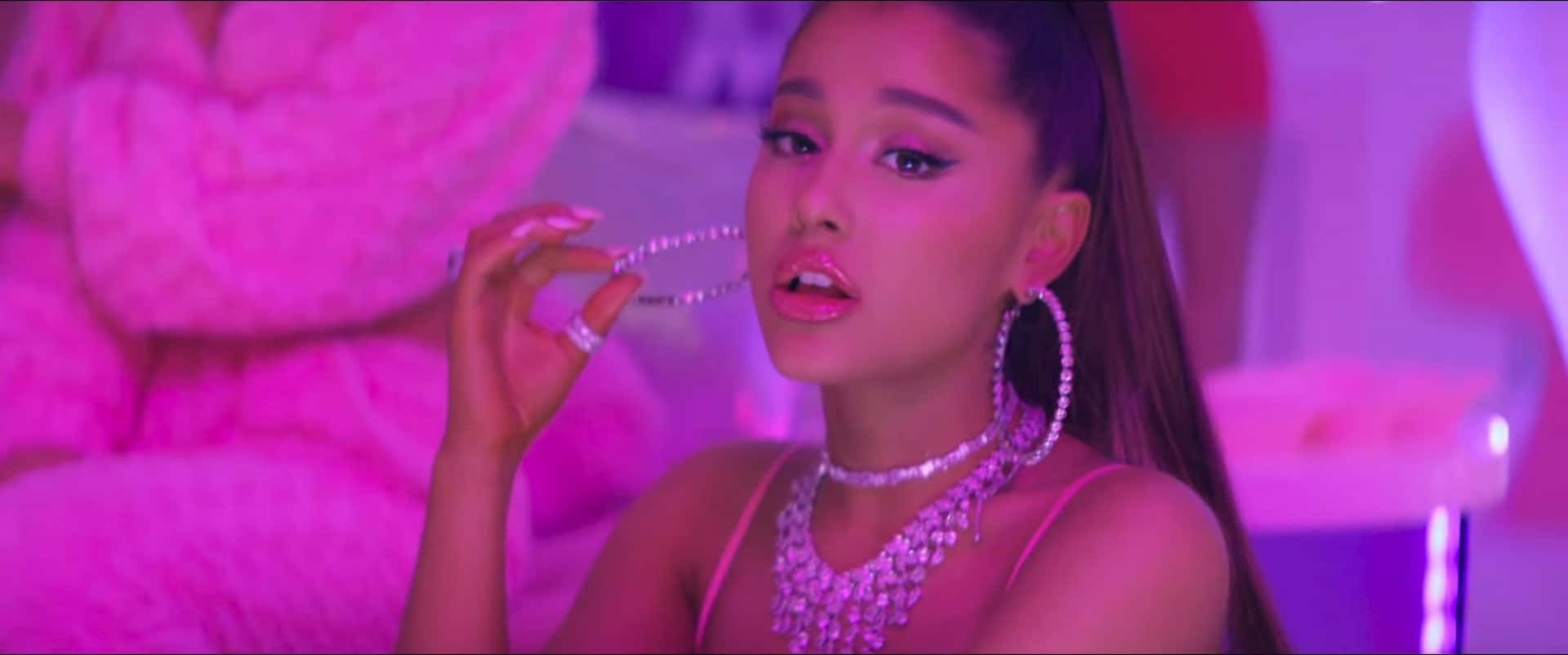 Ariana Grande Looks Fierce In A Red Dress, Halo And Diamond Rings. Background