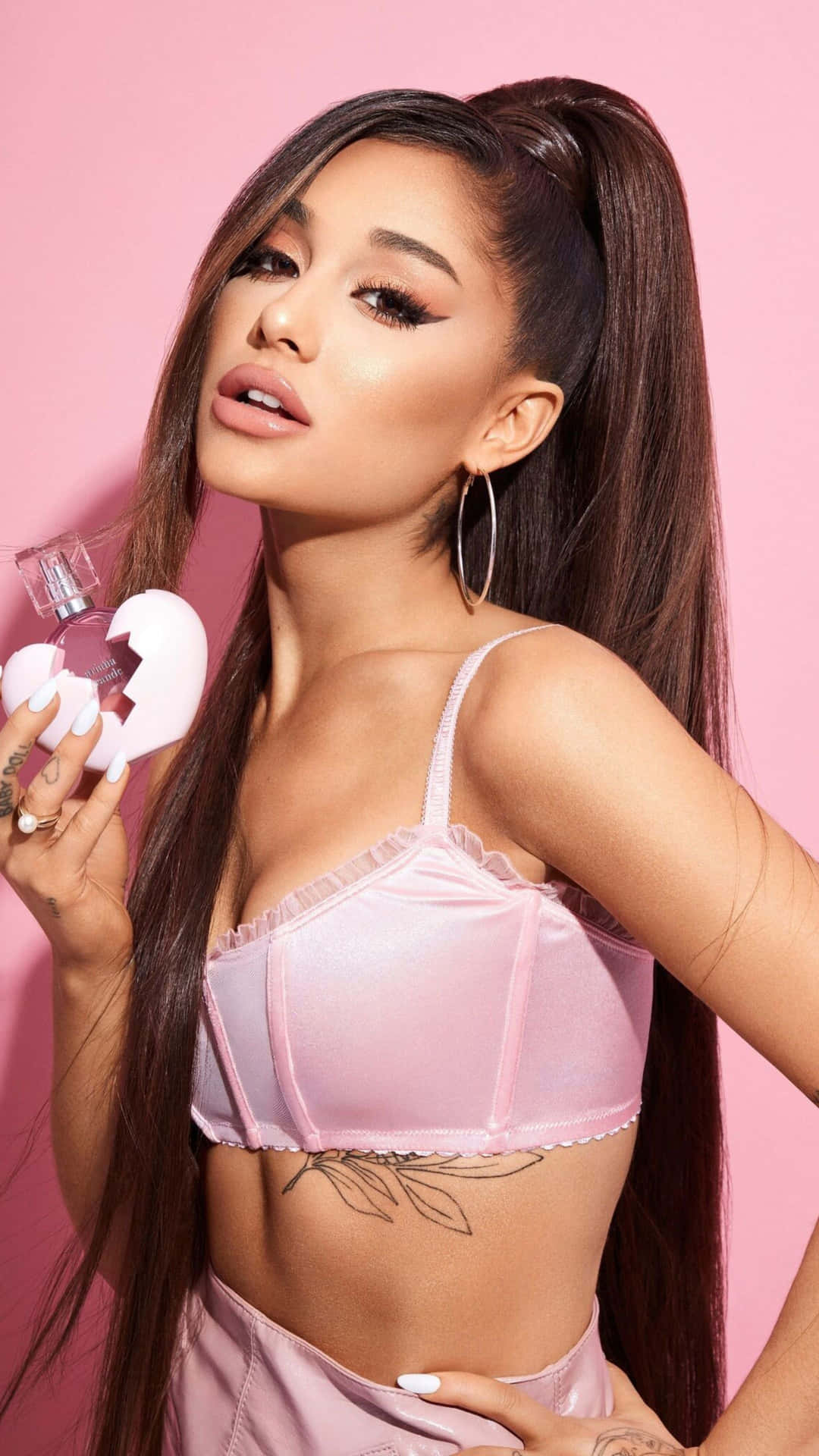 Ariana Grande Pink Backdrop Promoting Fragrance Background