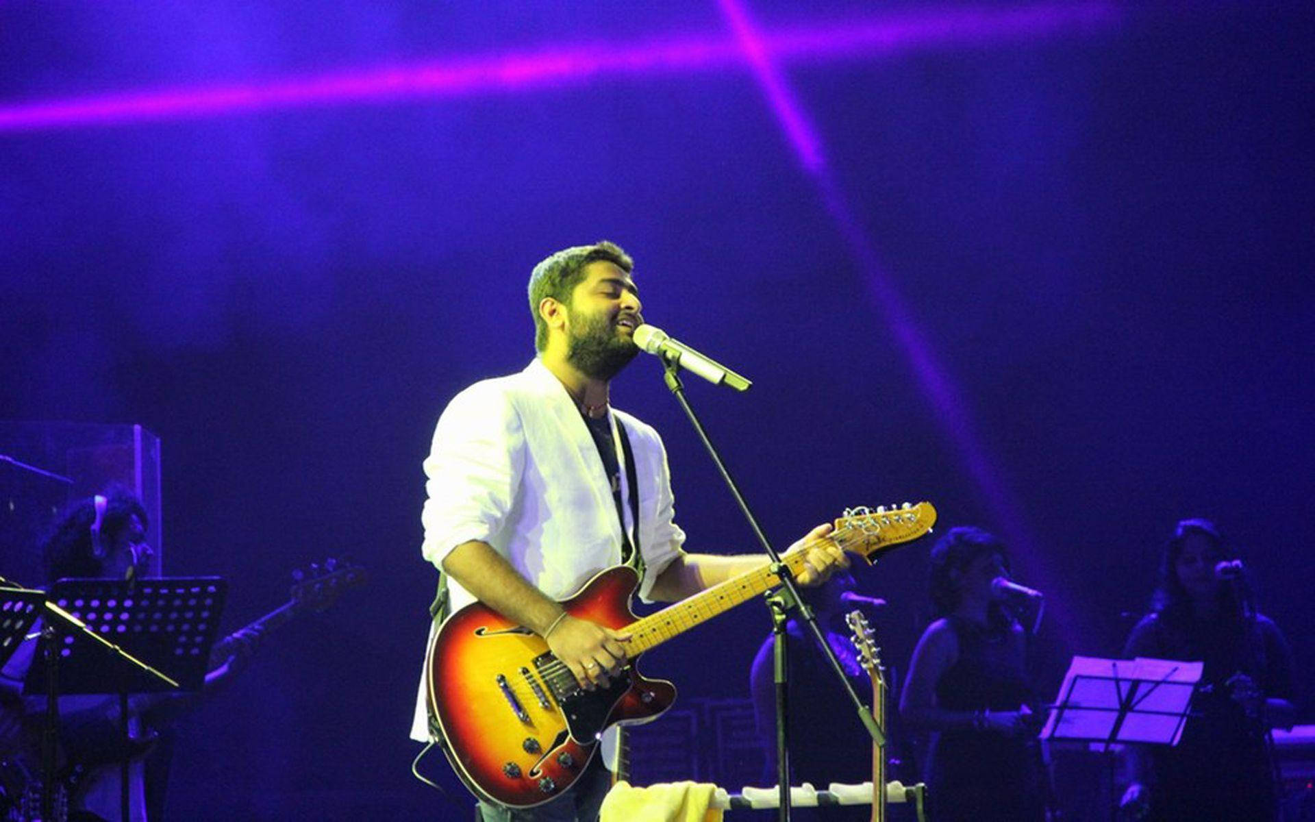 Arijit Singh Delivering A Powerful Performance With His Band Background