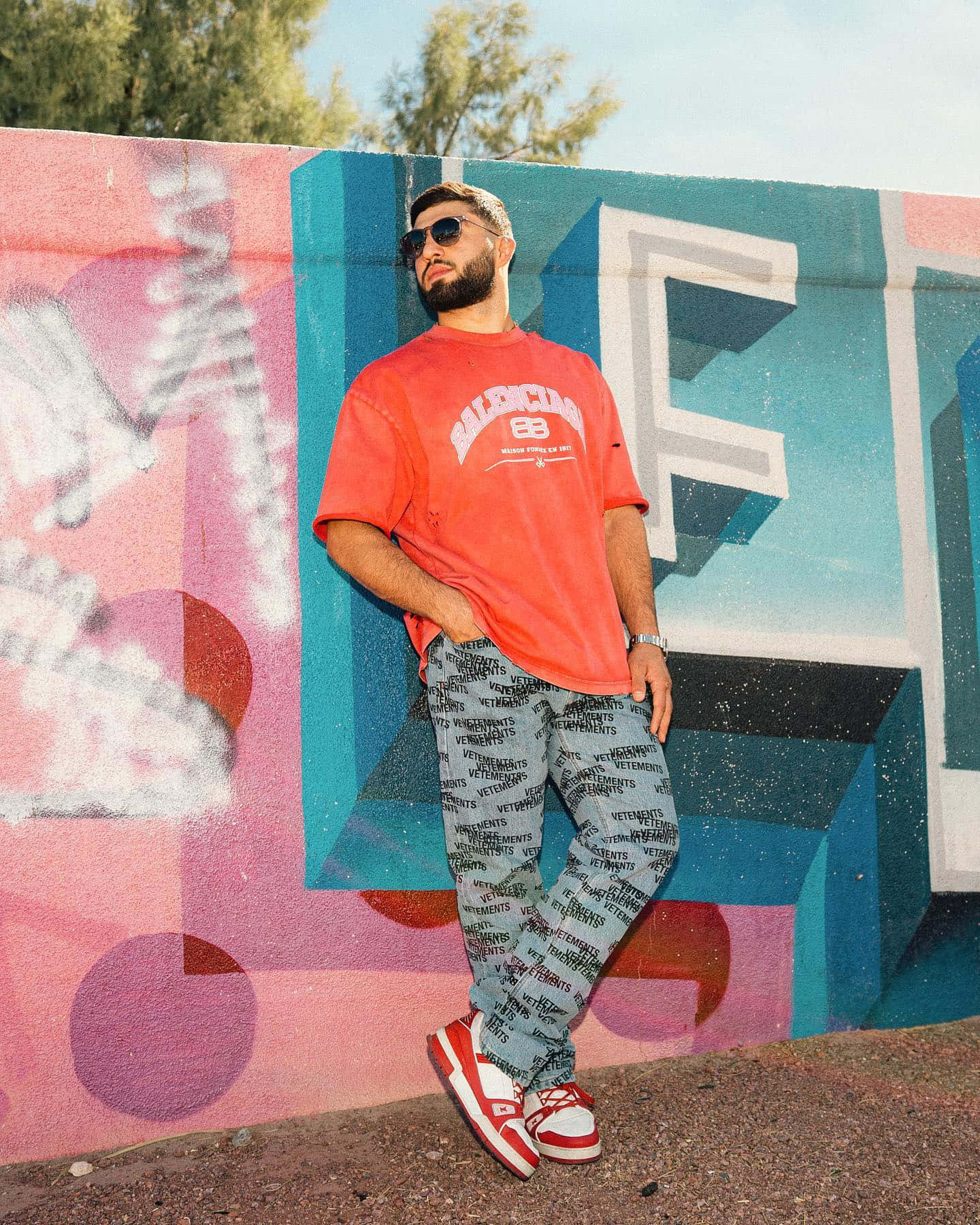 Arman Tsarukyan Leaning Against Colorful Wall Background