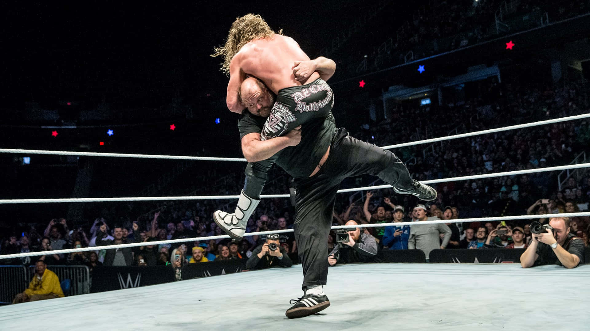 Arn Anderson Executing Spinebuster Move On Dolph Ziggler In A Wrestling Match Background