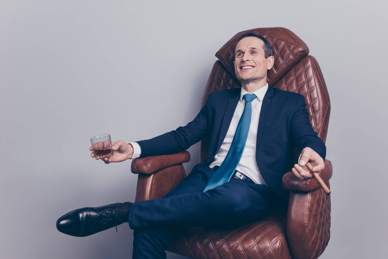 Arrogant Businessman Sitting On Leather Chair