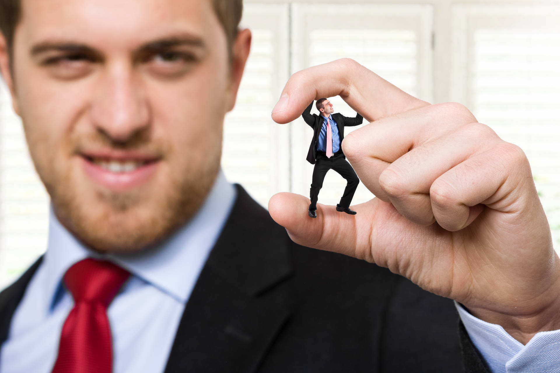 Arrogant Businessman Squishing Tiny Co-worker Background