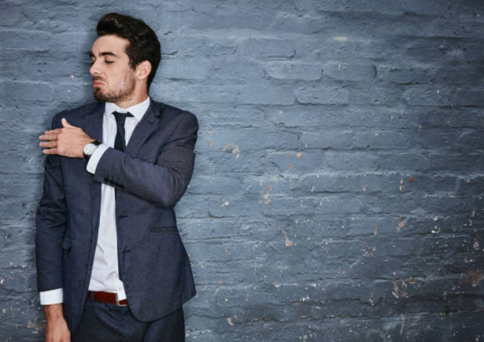 Arrogant Man Against Gray Brick Wall Background