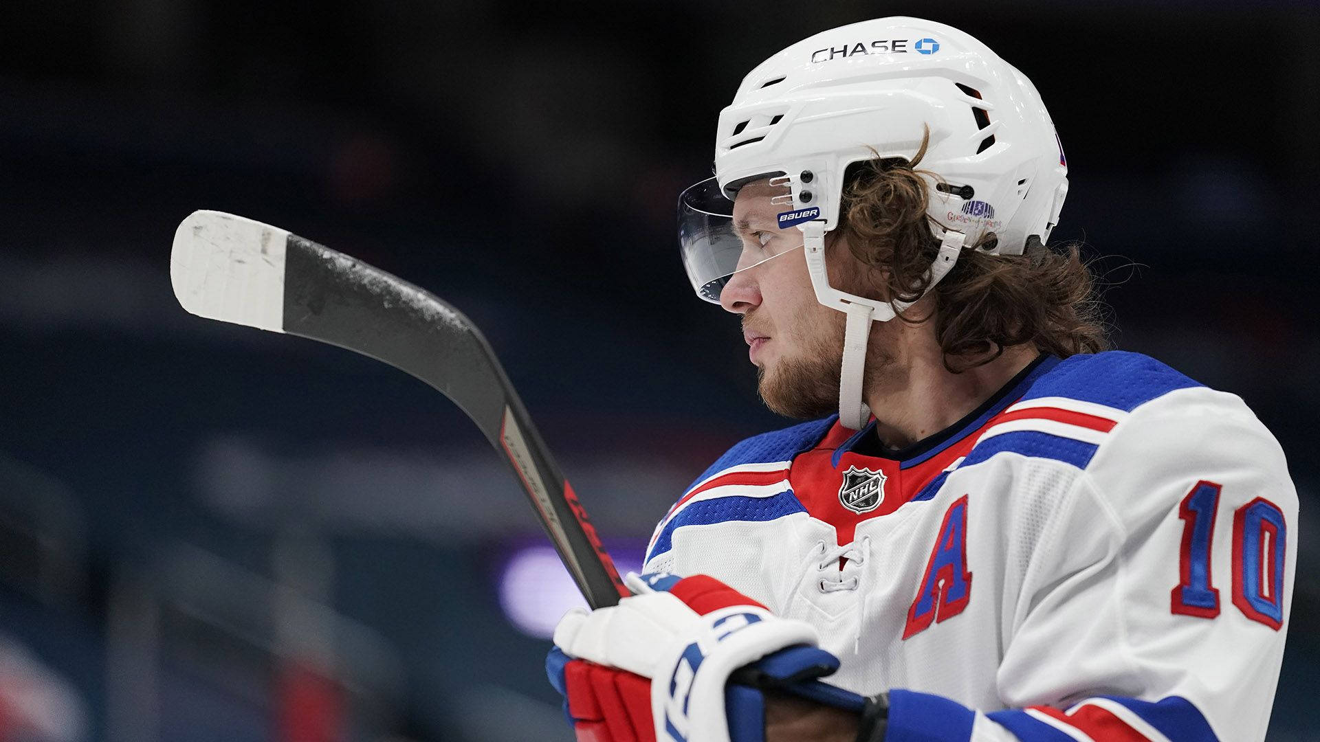 Artemi Panarin Holding A Hockey Stick Background