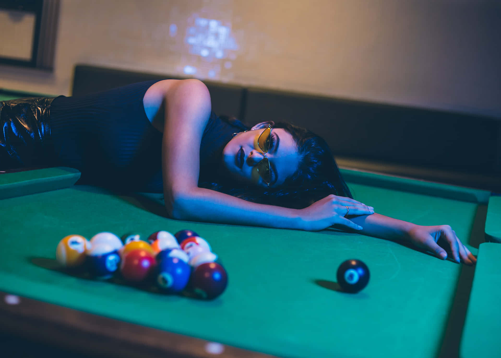 Artistic Image Of A Woman Lounging On A Pool Table Background