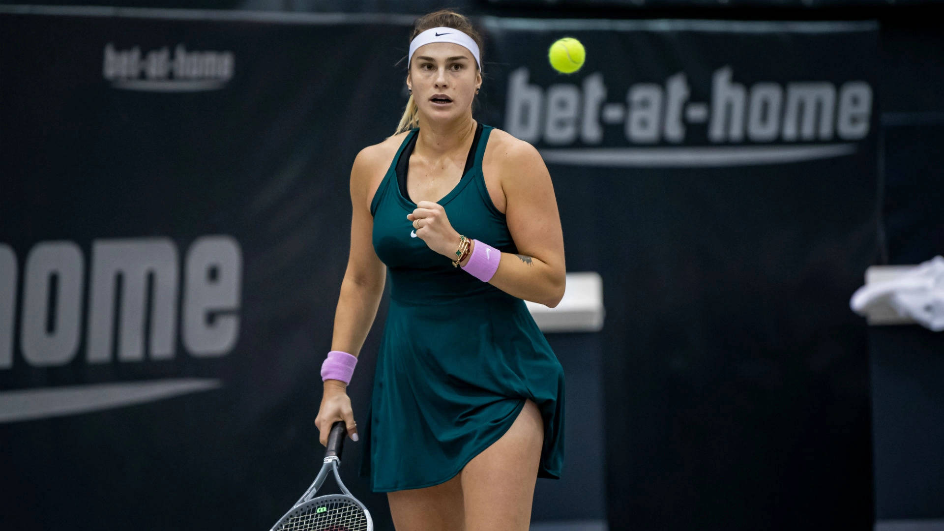 Aryna Sabalenka Approaching Tennis Ball Background