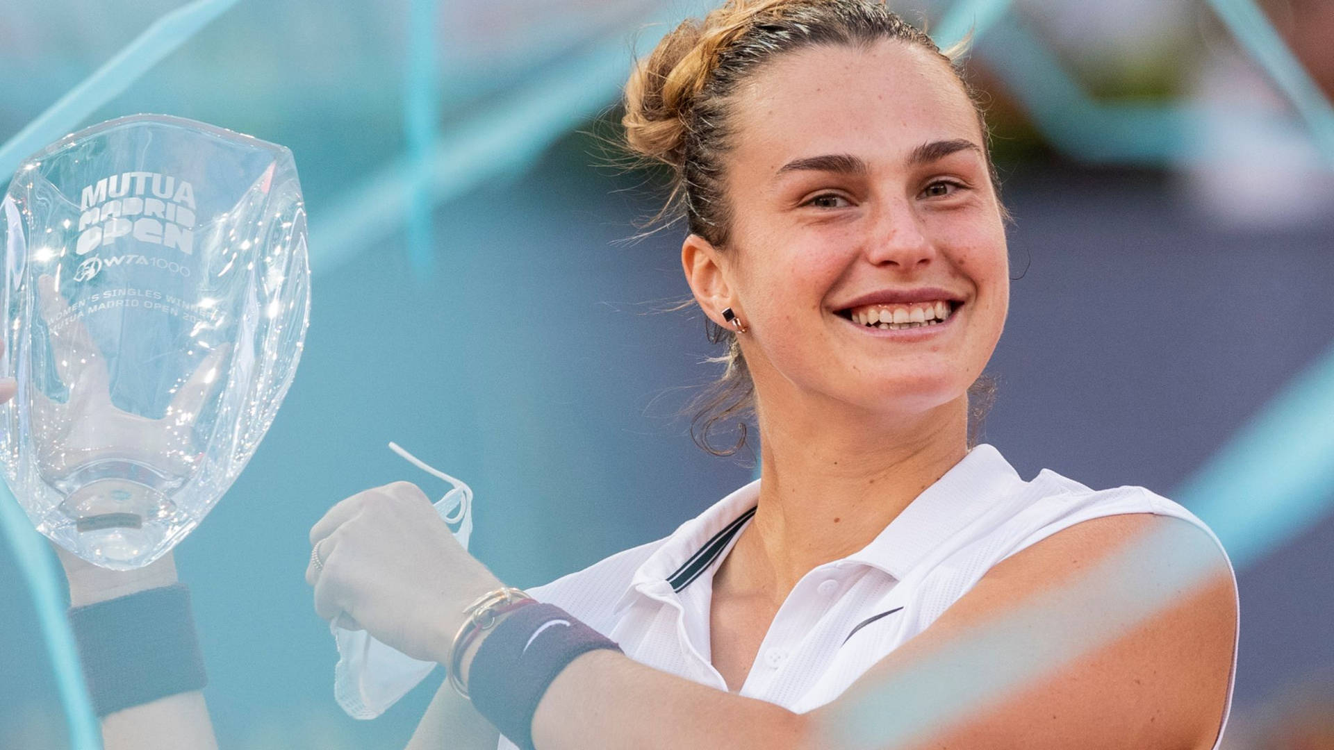 Aryna Sabalenka Holding Mutua Madrid Open Trophy Background