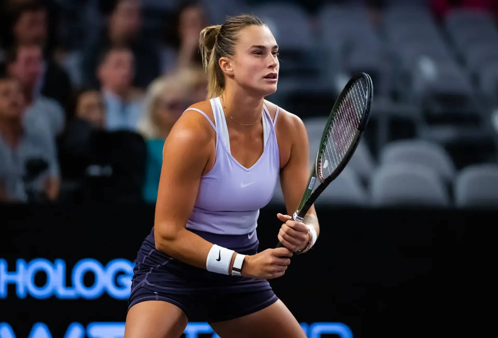 Aryna Sabalenka Holding Racket Both Hands Background