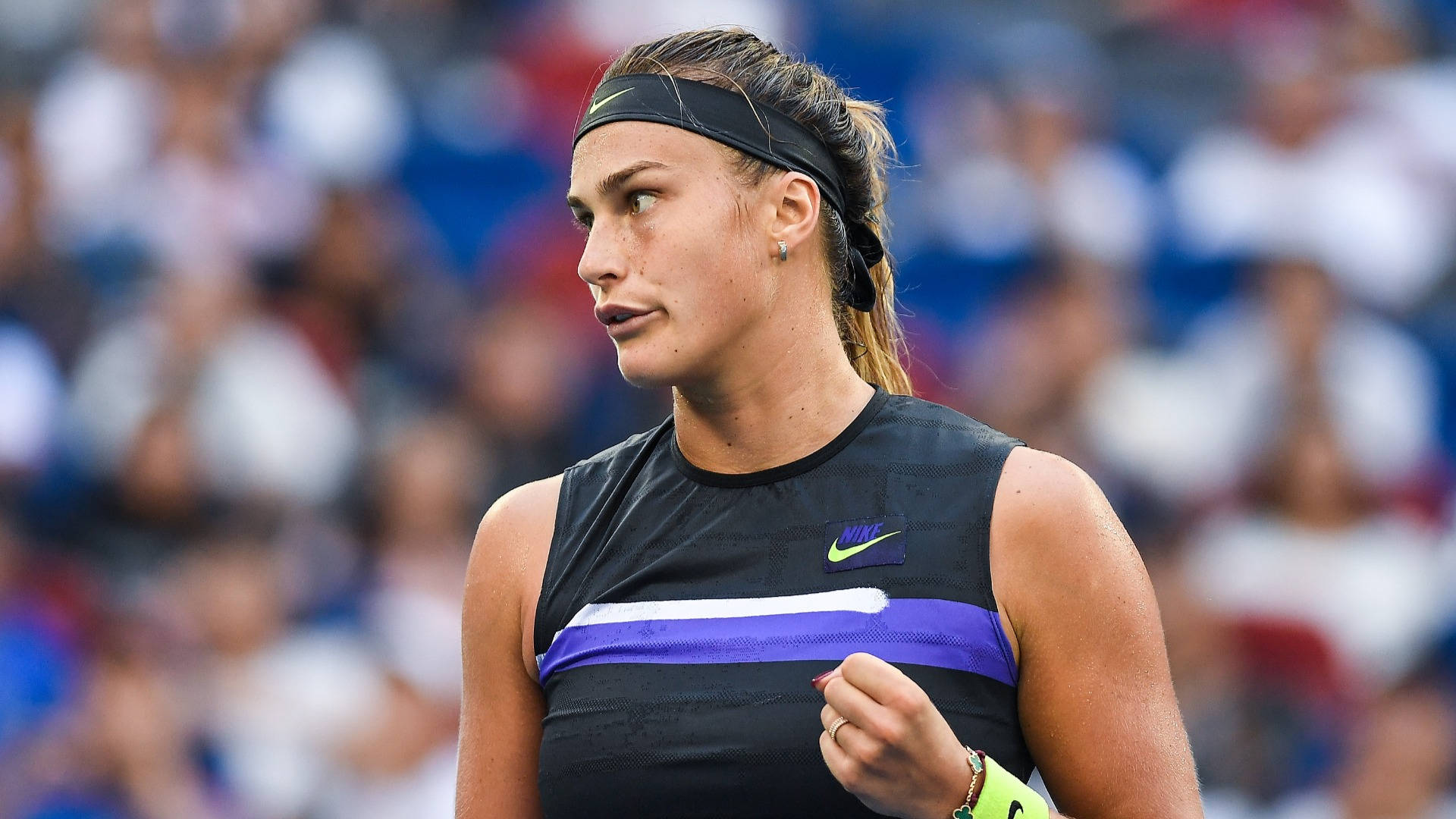 Aryna Sabalenka In Action - Tennis Pro With Black Headband Background