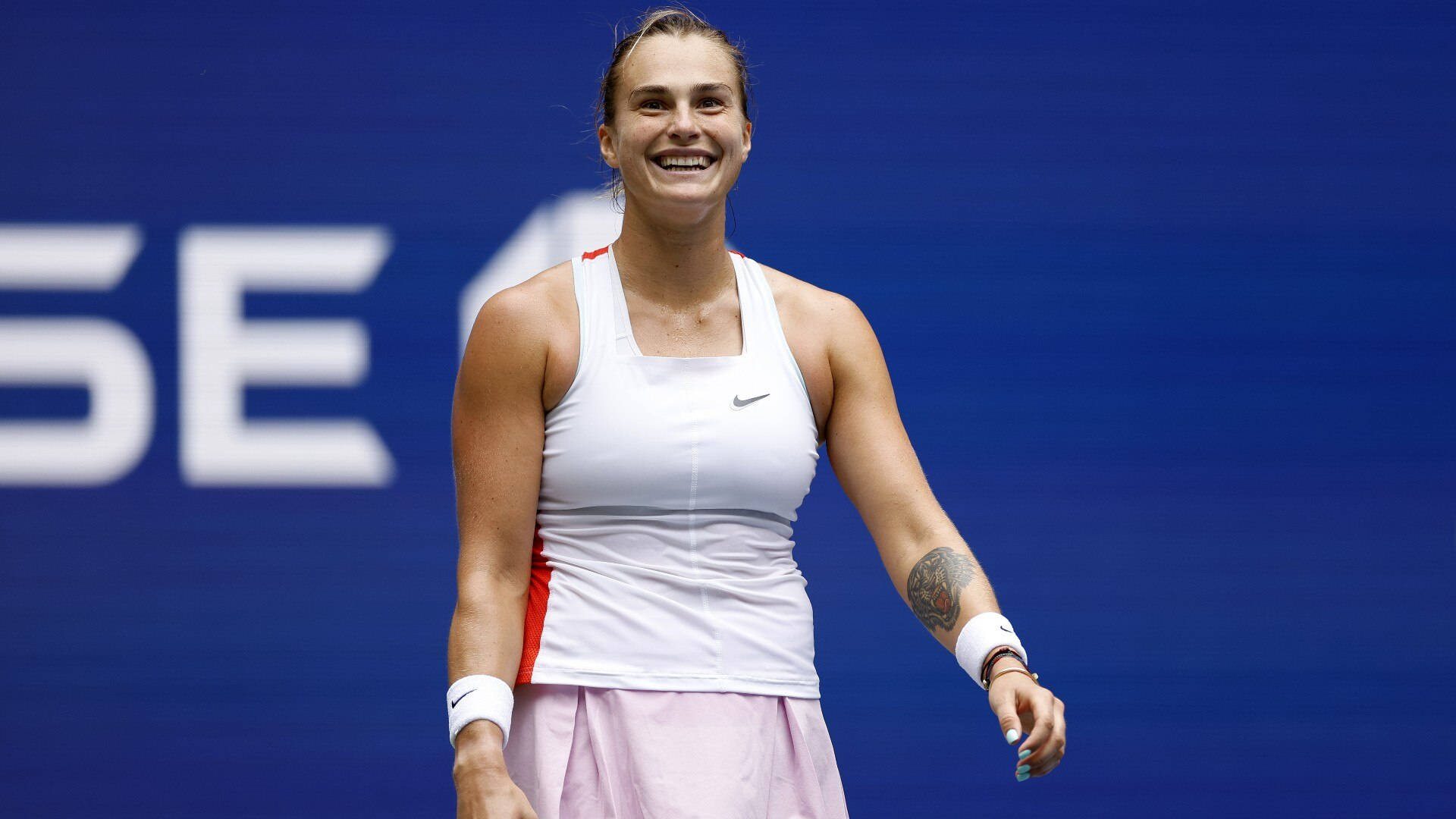 Aryna Sabalenka - Professional Tennis Player With Winning Smile Background