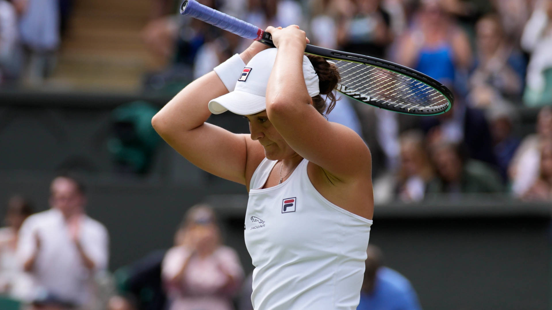 Ashleigh Barty Holding Racket Above Head Background