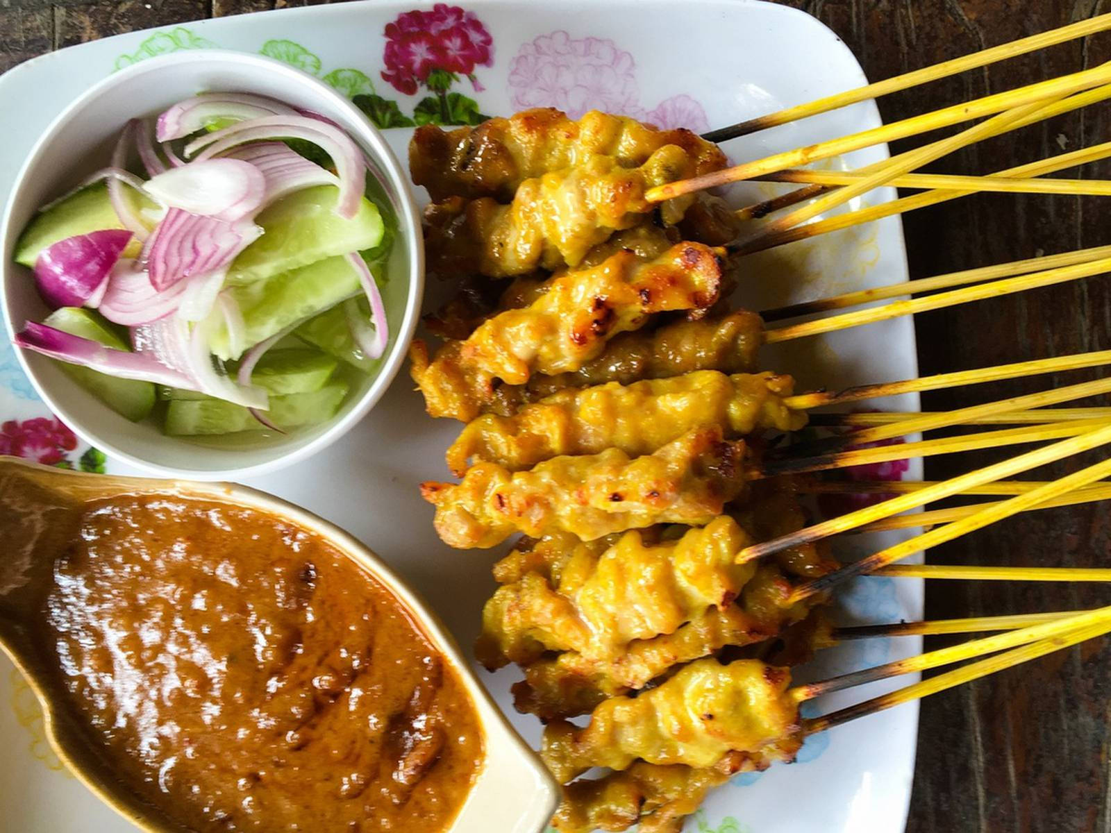 Asian Delight: A Scrumptious Plate Of Chicken Satay With Cucumber Salad