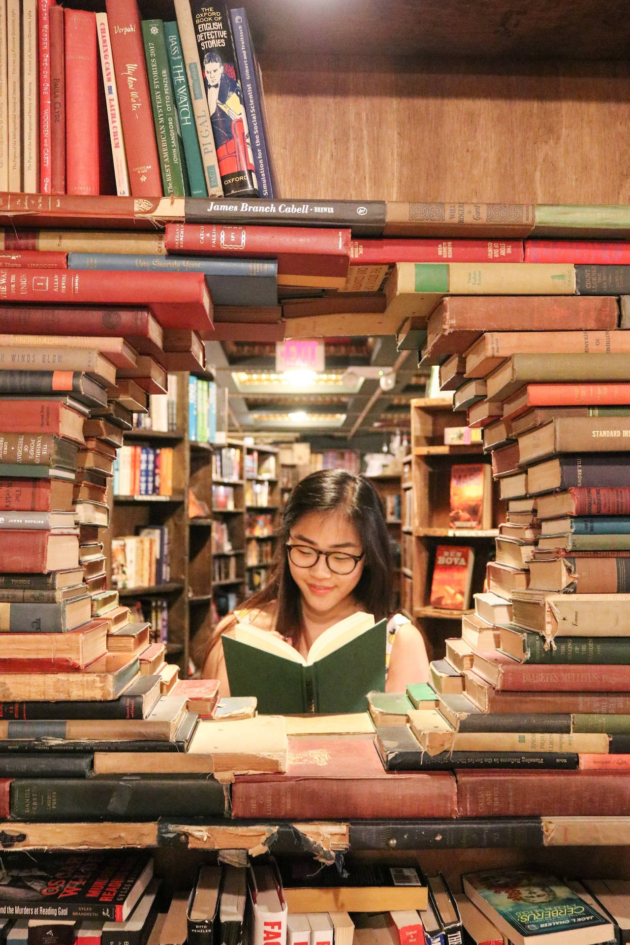 Asian Teenage Girl Reading A Book In Library