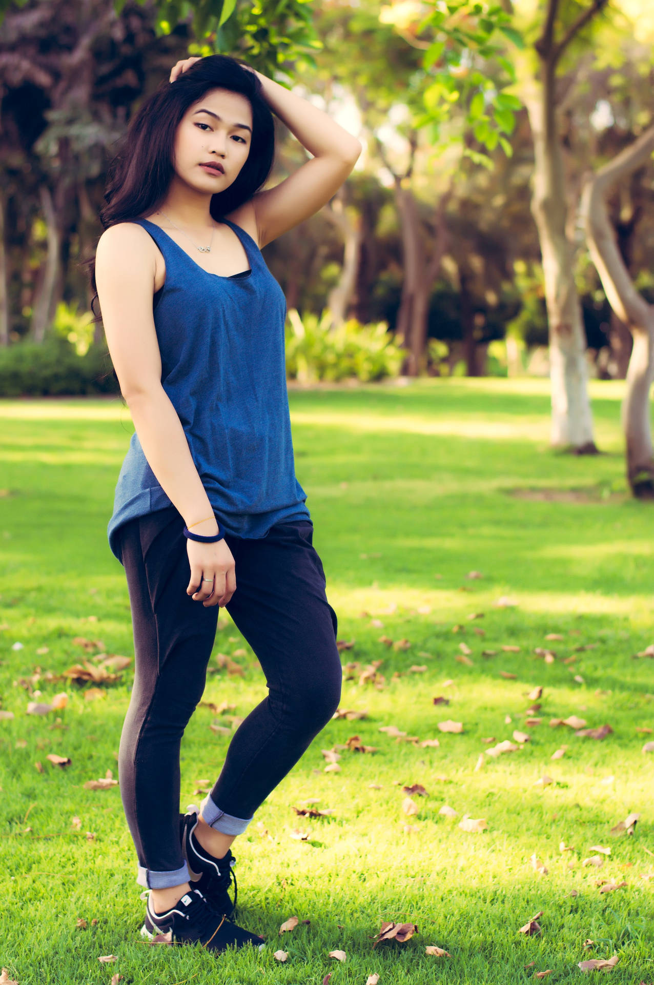 Asian Woman In Blue Tank Top Background