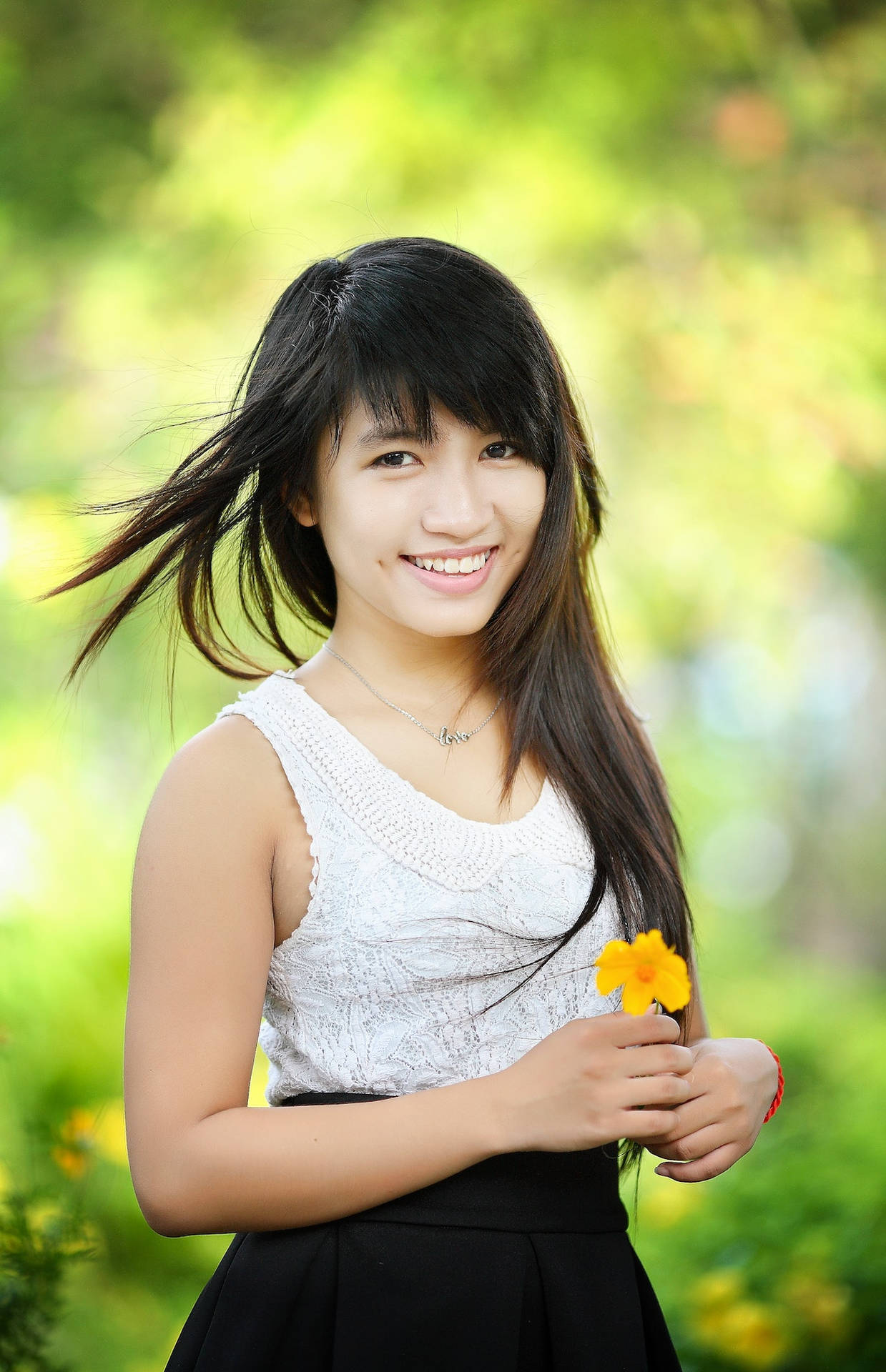 Asian Woman With A Yellow Flower Background