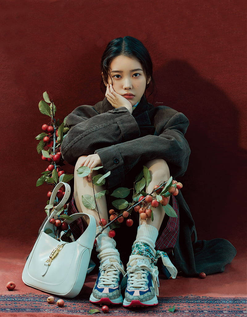 Asian Women Iu Sitting On The Floor Background