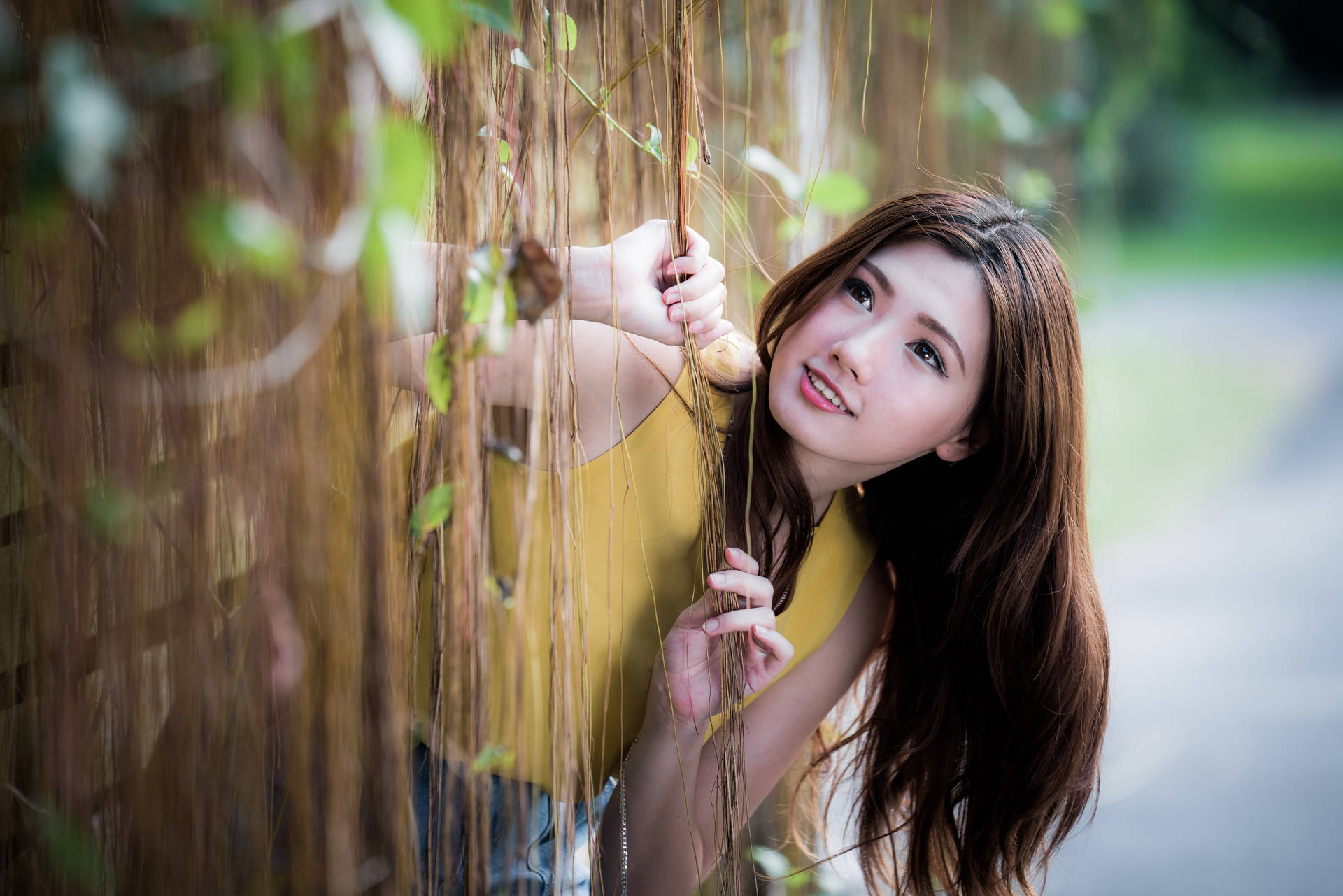 Asian Women Peeking Through Vines Background