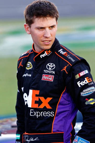 Assertive Denny Hamlin Dressed In Black Racing Outfit