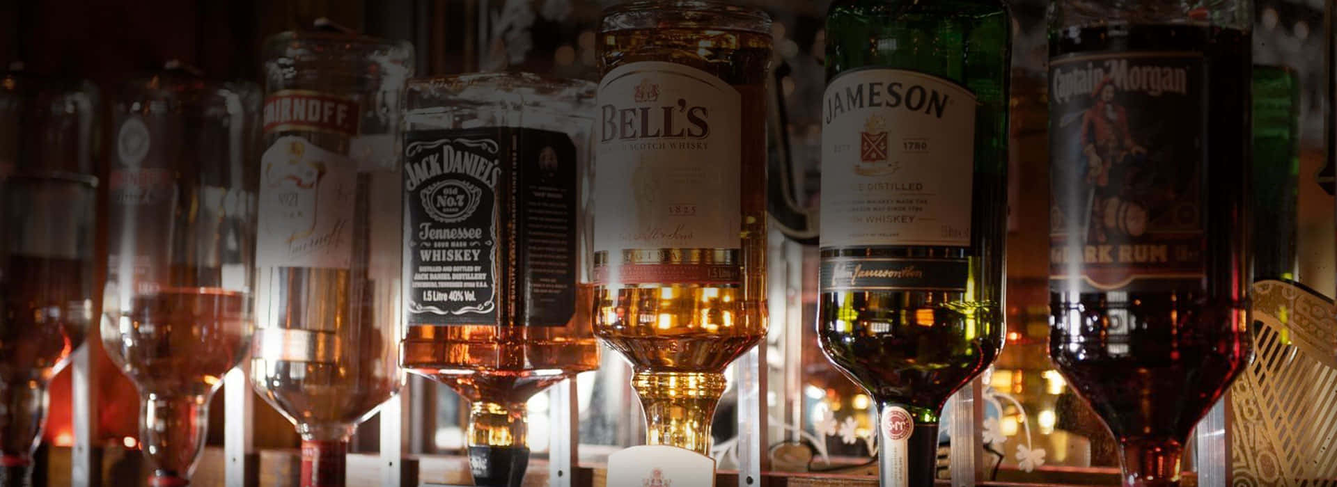 Assorted Liquor Bottleson Bar Backlighting Background