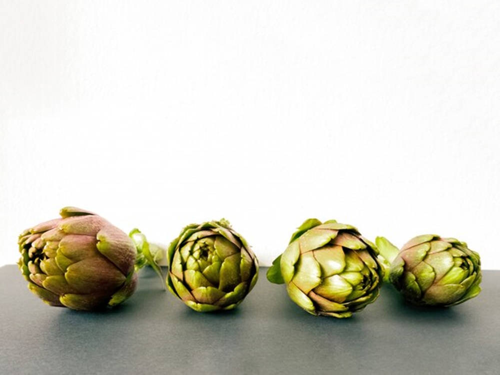 Assorted Sizes Of Fresh Artichokes Background