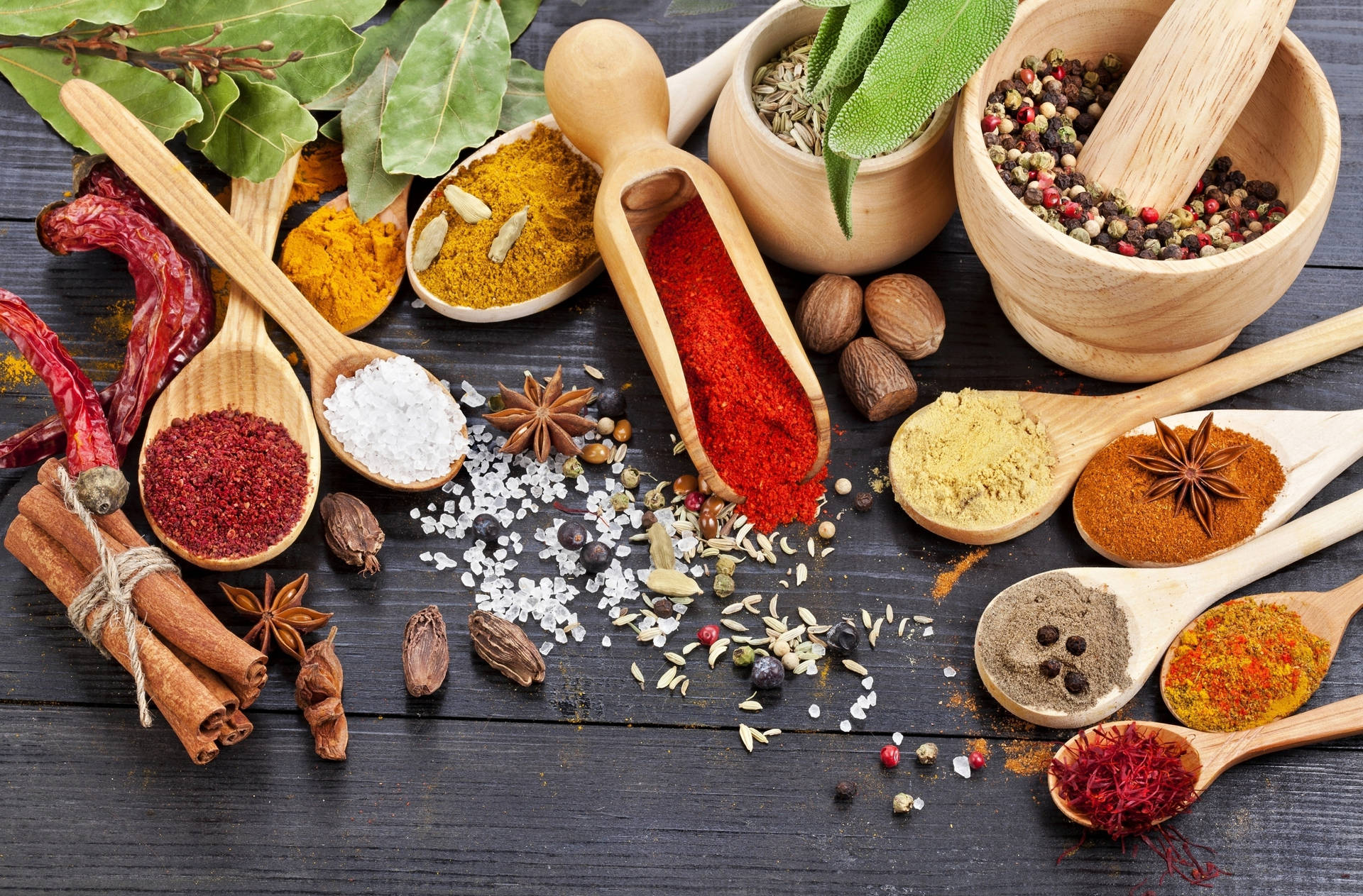 Assortment Of Spices Amidst Wooden Utensils