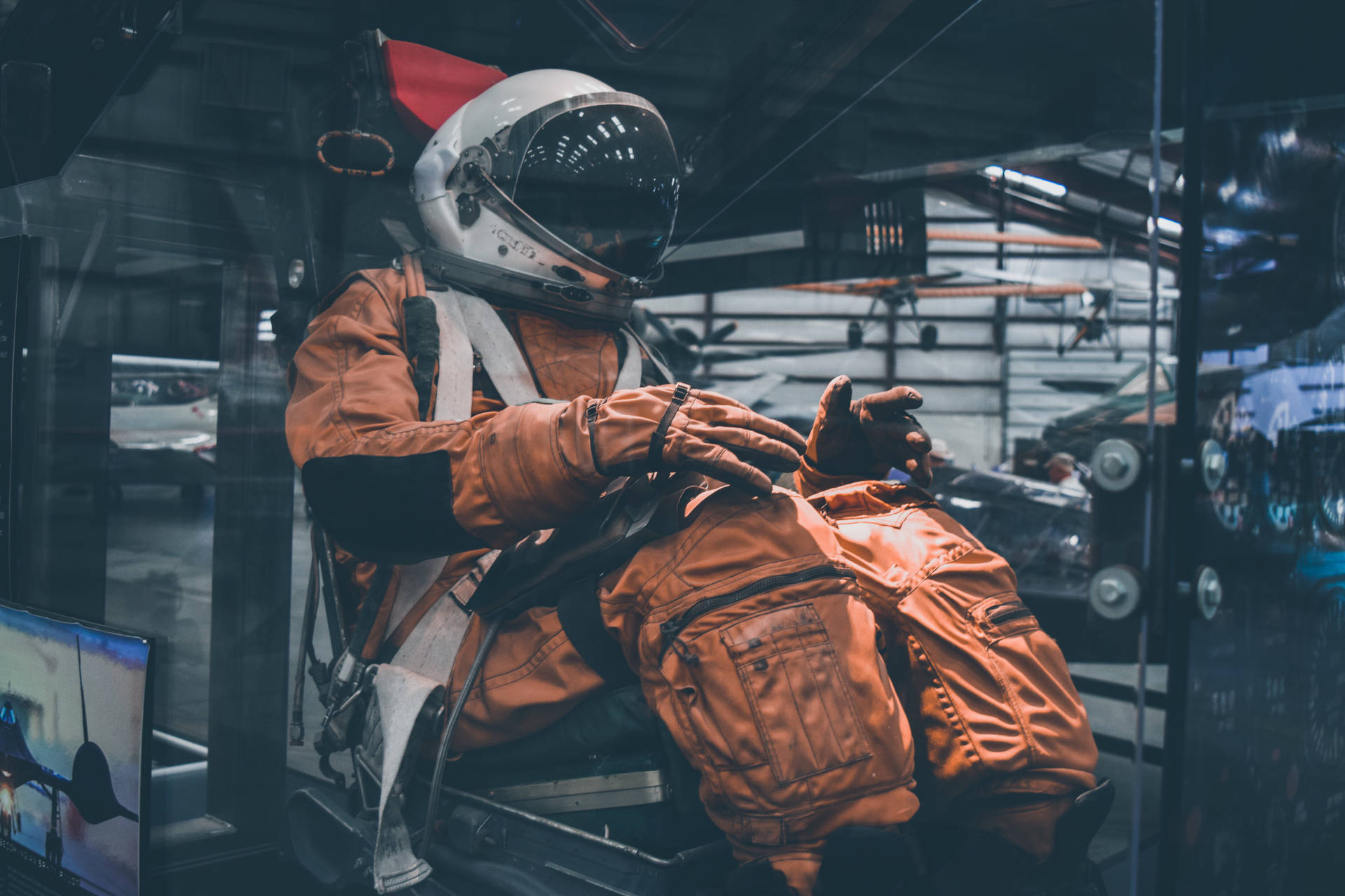 Astronaut In Space Wearing Orange Suit Background