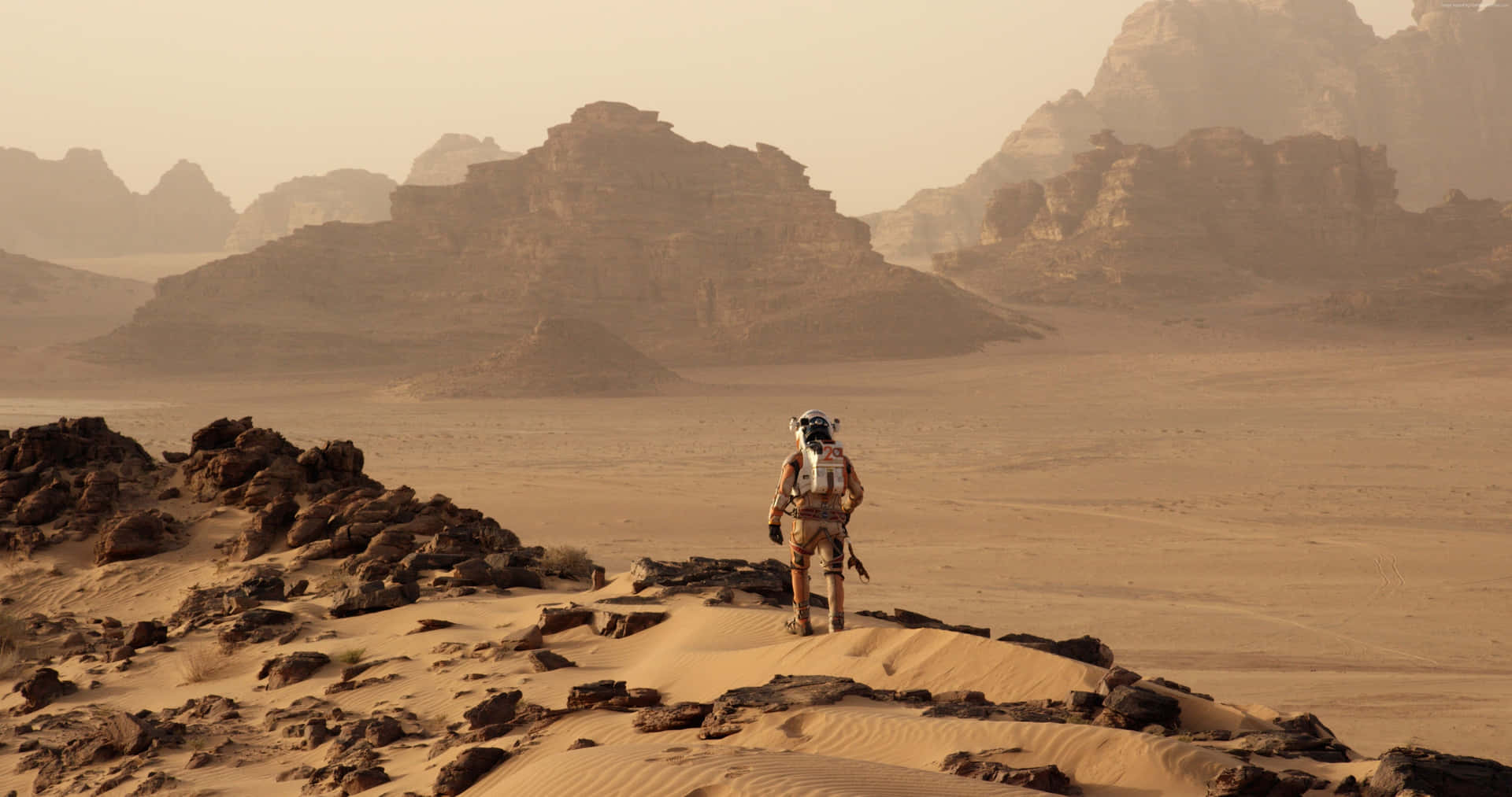Astronaut Mark Watney Standing On The Rocky Terrain Of Mars. Background